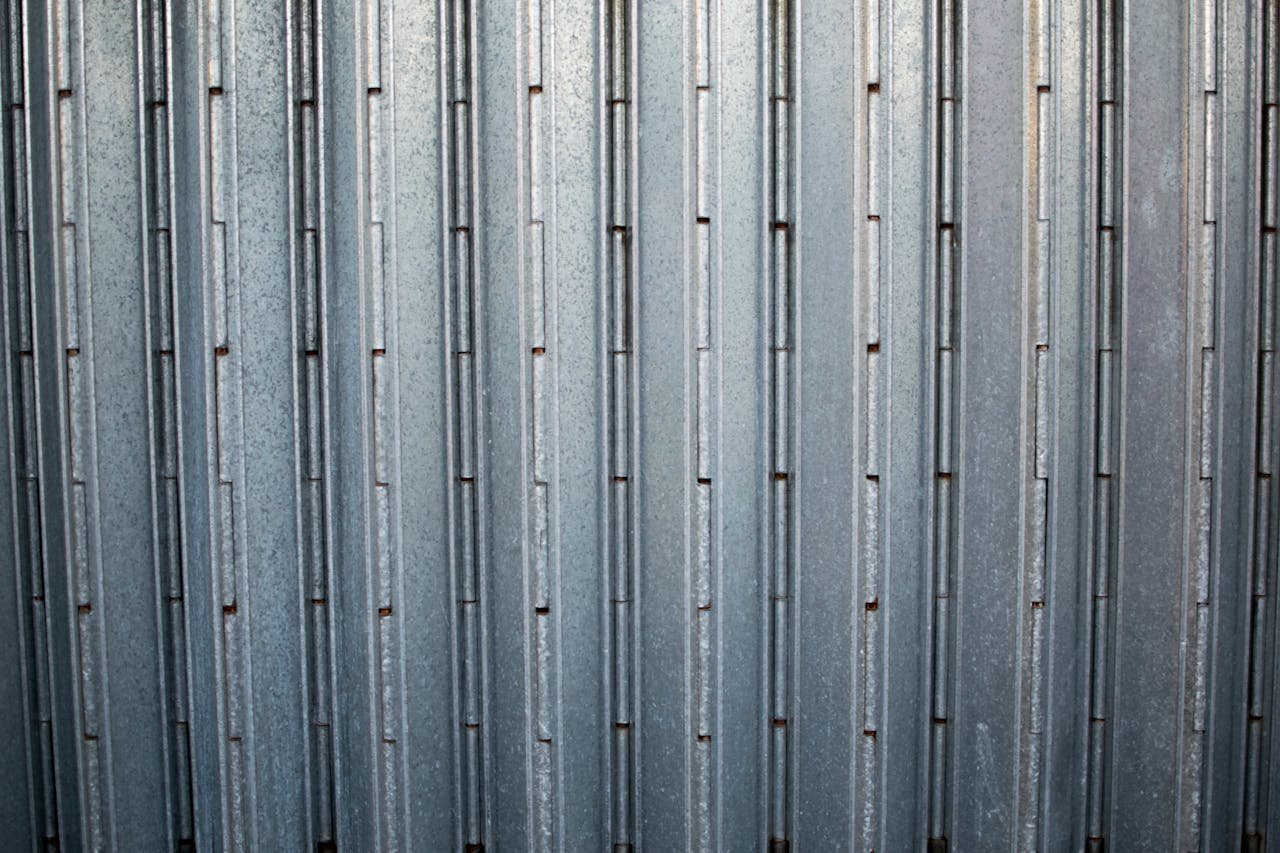 Close-up of a grey corrugated metal surface showcasing its uniform pattern and sturdy construction.